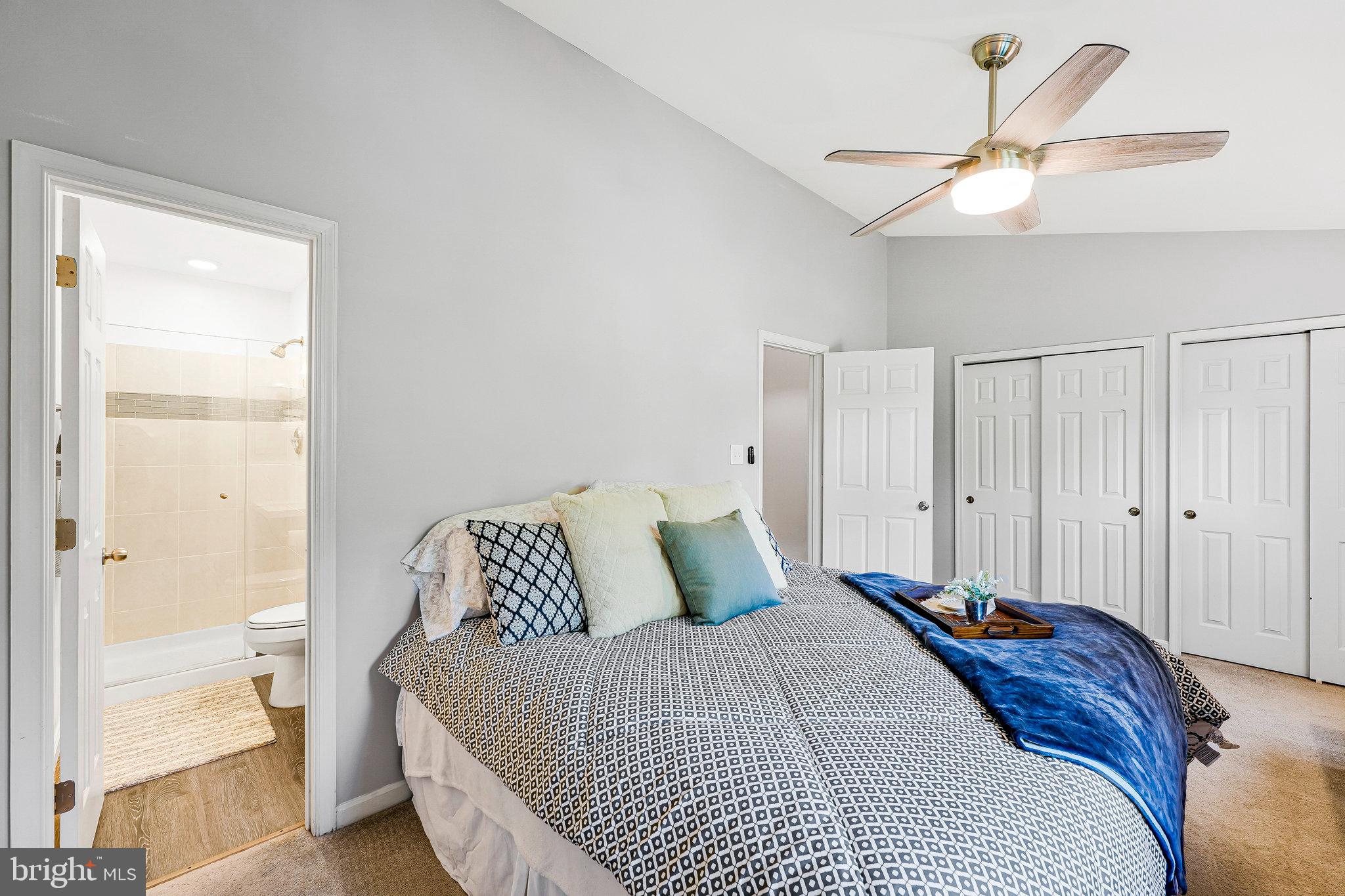 1085 Smartts Lane Northeast Leesburg, VA 20176 - Photo 20 of 38 a bedroom with a bed and a lamp