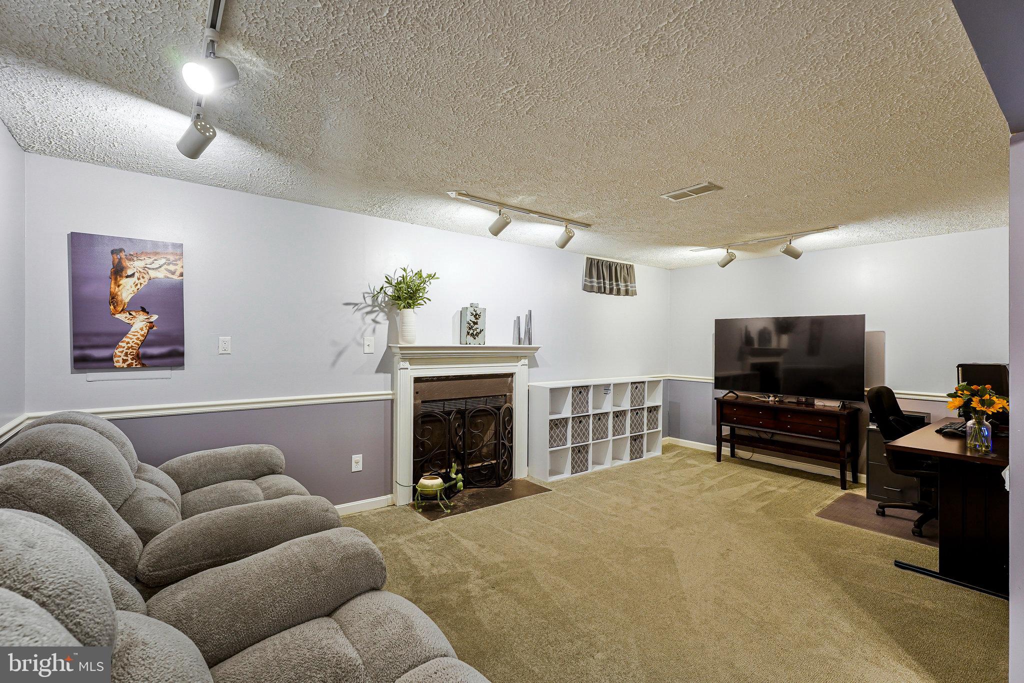 1085 Smartts Lane Northeast Leesburg, VA 20176 - Photo 26 of 38 a living room with furniture and a flat screen tv