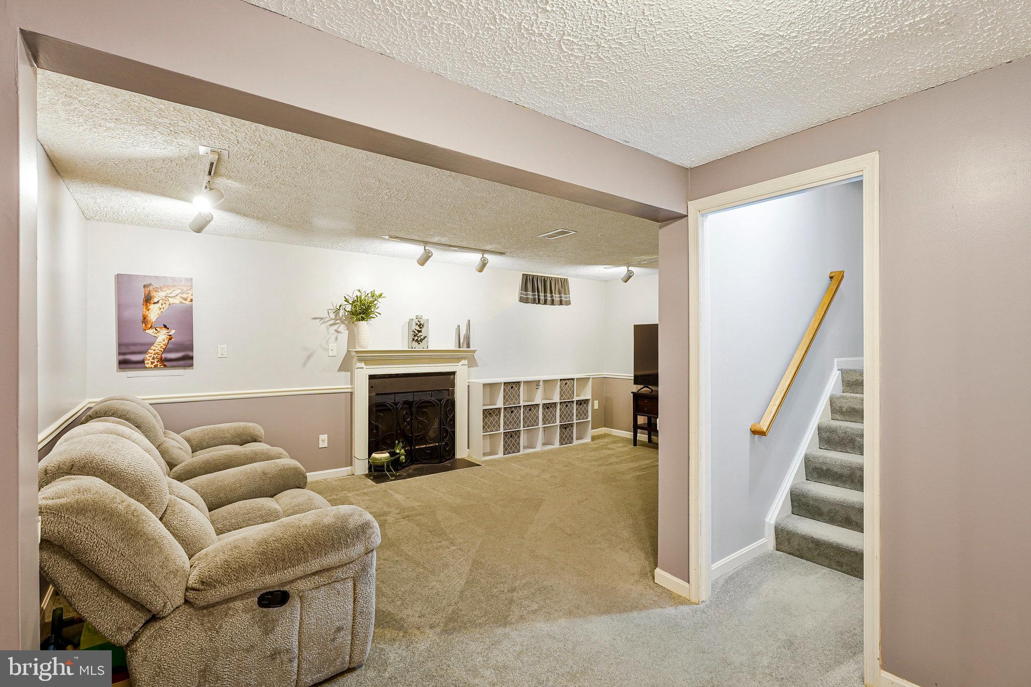 1085 Smartts Lane Northeast Leesburg, VA 20176 - Photo 28 of 38 a living room with furniture and a fireplace