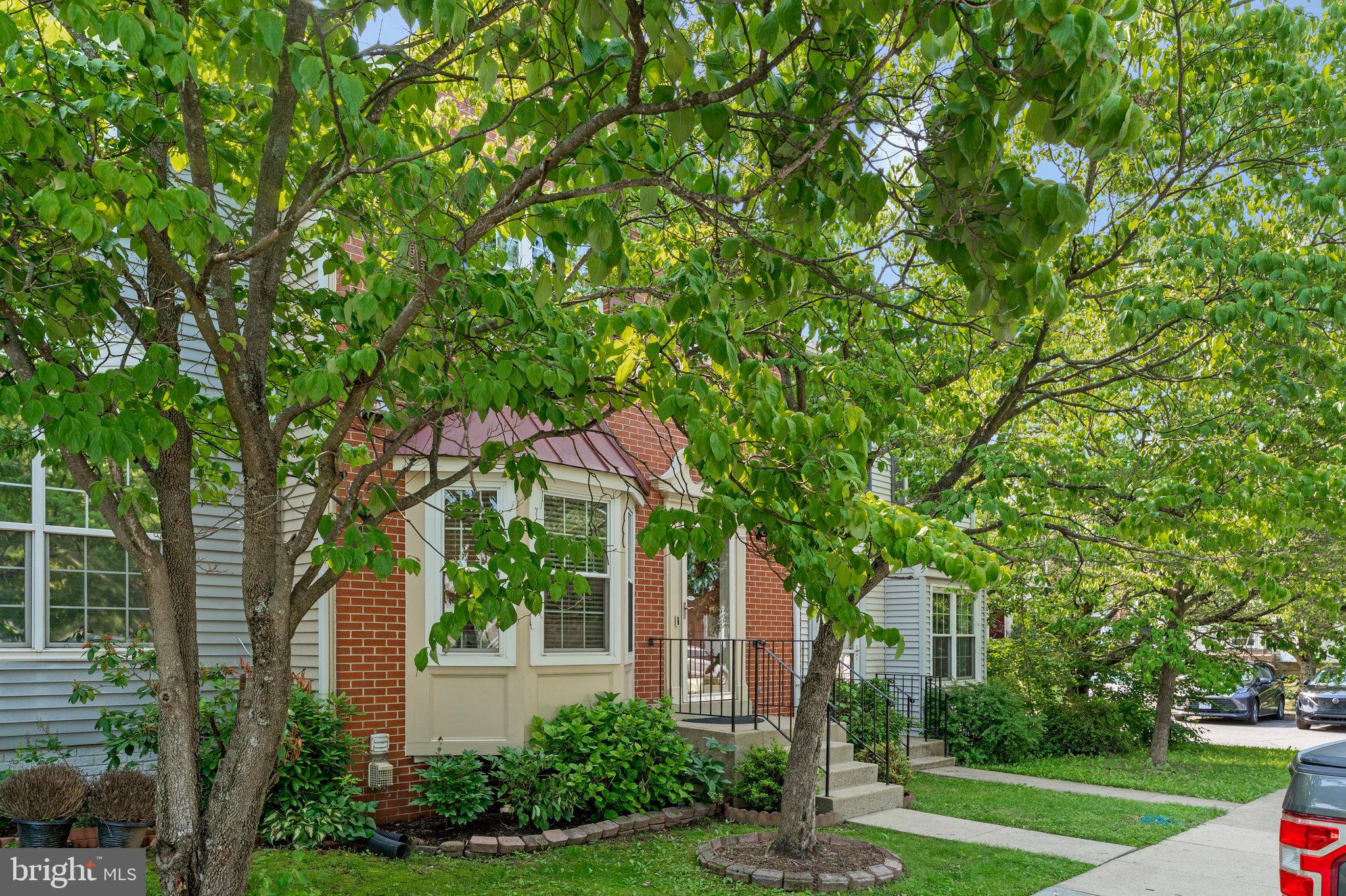 1085 Smartts Lane Northeast Leesburg, VA 20176 - Photo 3 of 38 a front view of a house with a yard and a tree