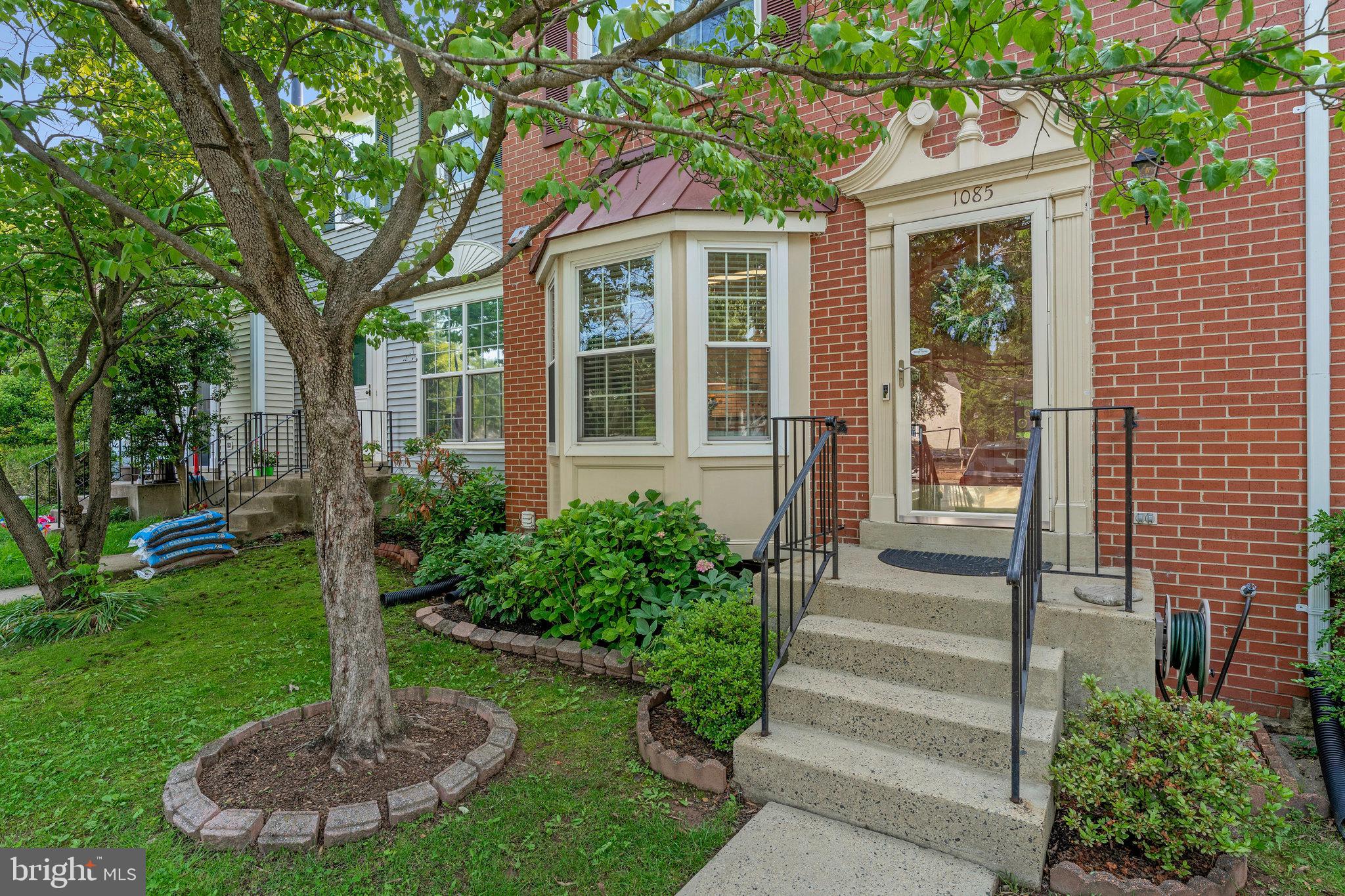 1085 Smartts Lane Northeast Leesburg, VA 20176 - Photo 4 of 38 a front view of a house with a yard garden and outdoor seating