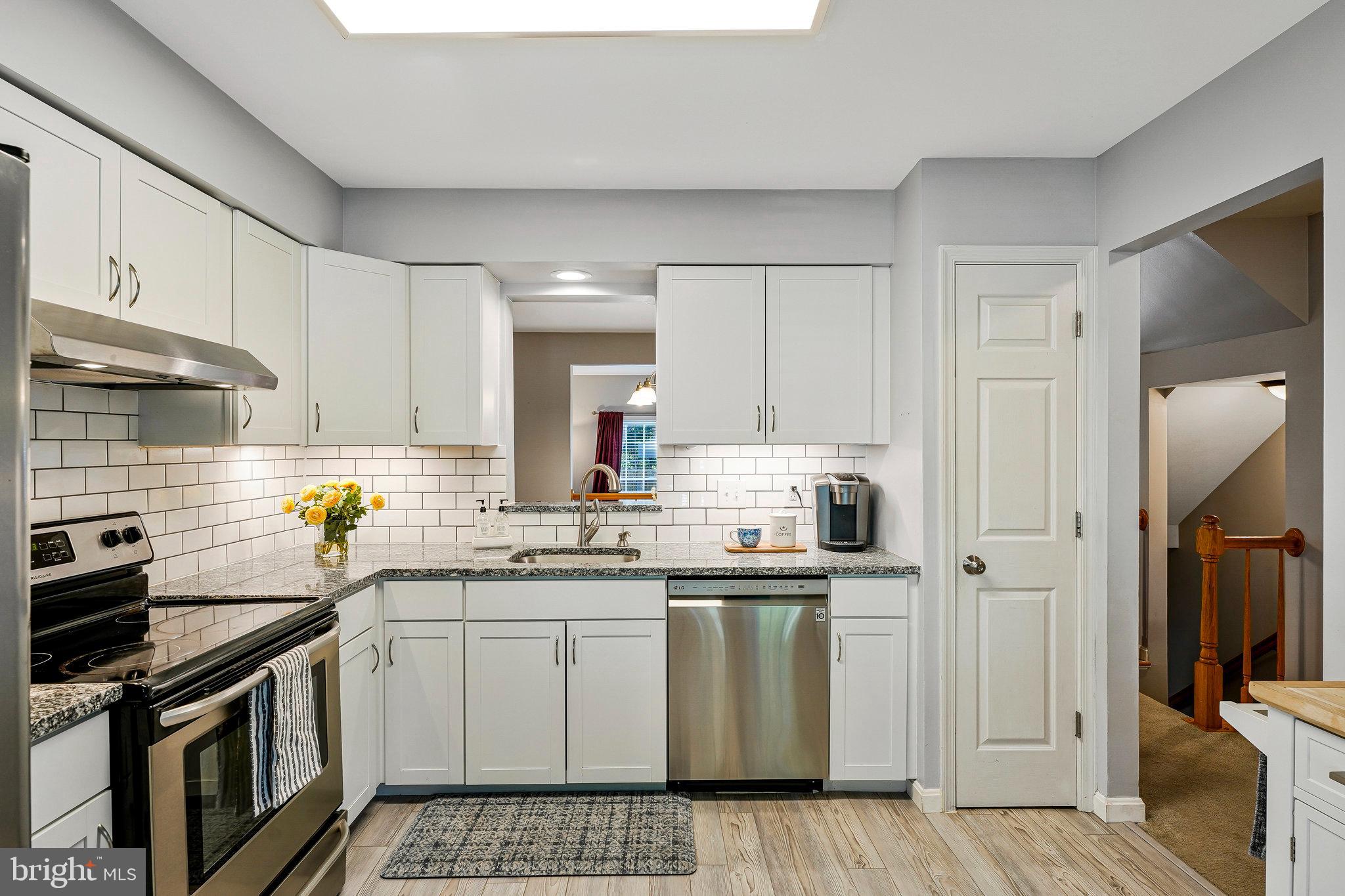 1085 Smartts Lane Northeast Leesburg, VA 20176 - Photo 6 of 38 a kitchen with stainless steel appliances a stove a sink and cabinets