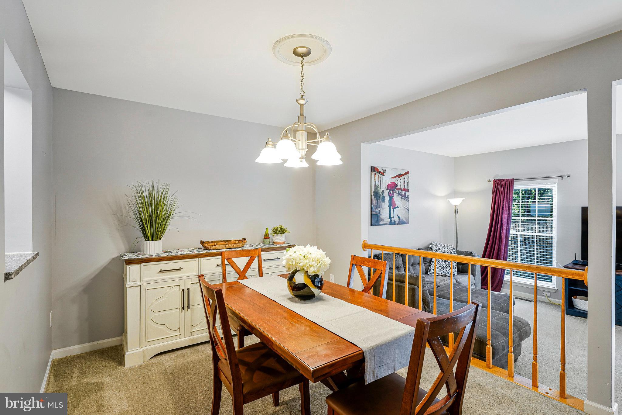 1085 Smartts Lane Northeast Leesburg, VA 20176 - Photo 10 of 38 a dining room with furniture a chandelier and window
