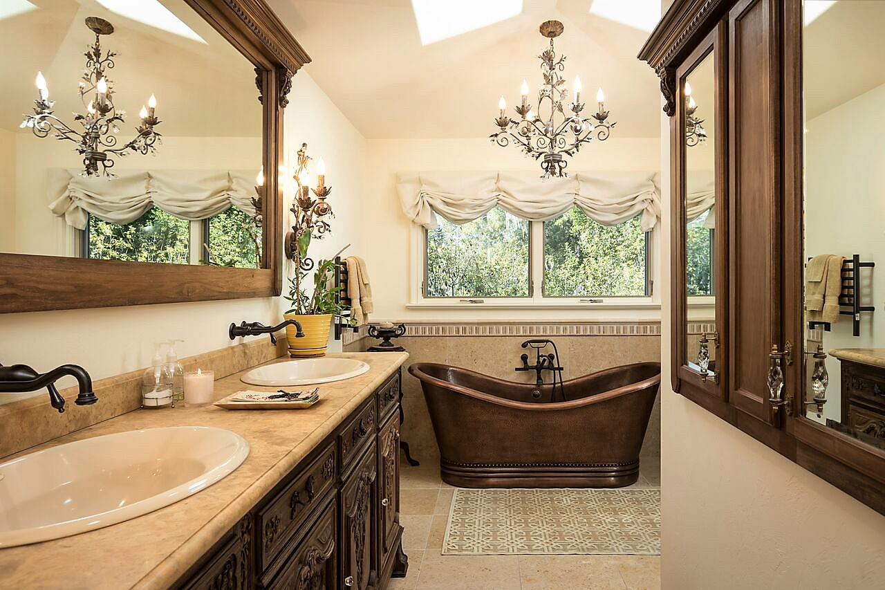 1035 Ortega Road Pebble Beach, CA 93953 - Photo 12 of 18 a bathroom with a granite countertop sink and a large mirror