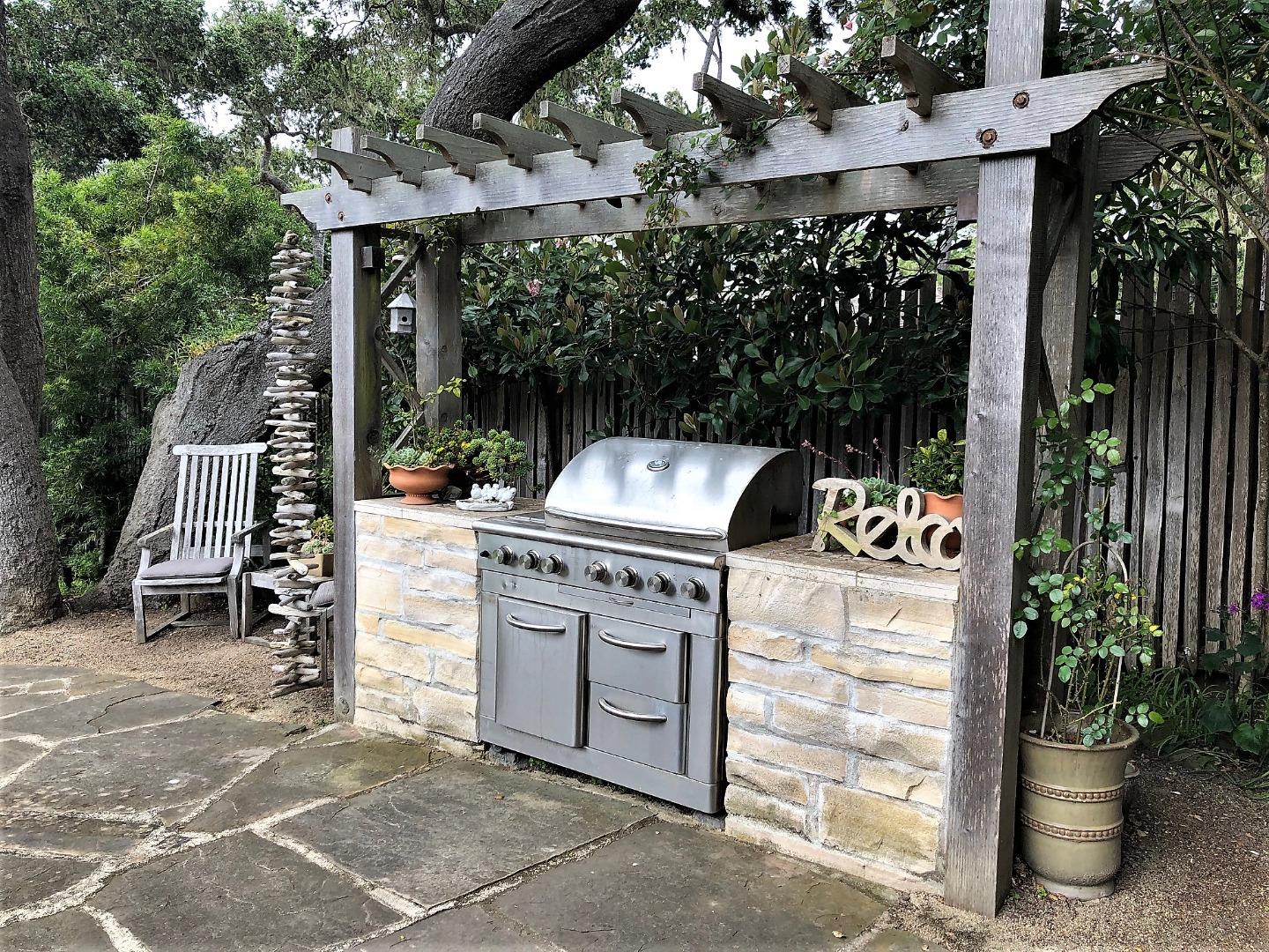 1035 Ortega Road Pebble Beach, CA 93953 - Photo 13 of 18 a view of a patio with table and chairs and a barbeque