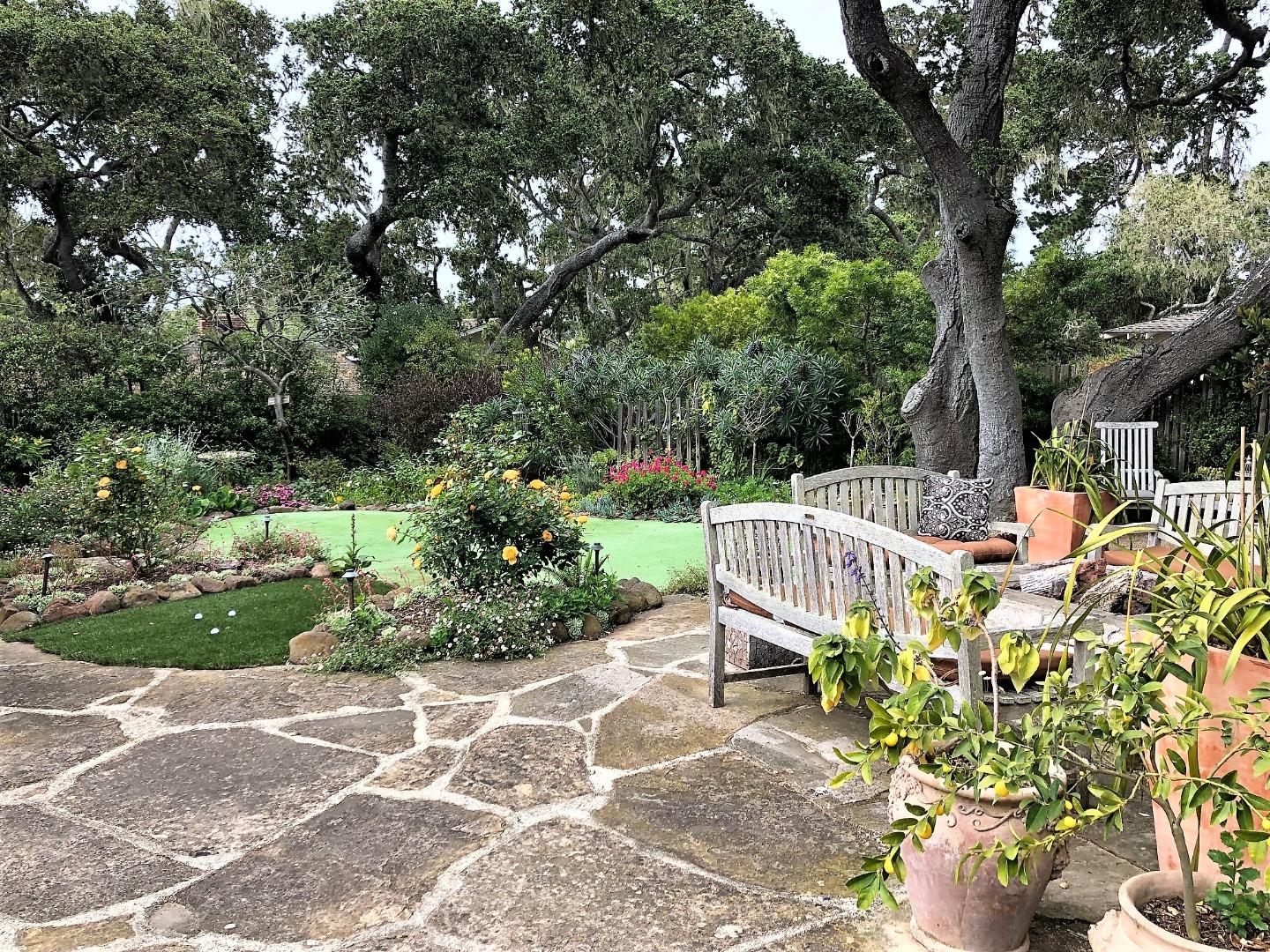 1035 Ortega Road Pebble Beach, CA 93953 - Photo 15 of 18 a view of a chair and table in the garden