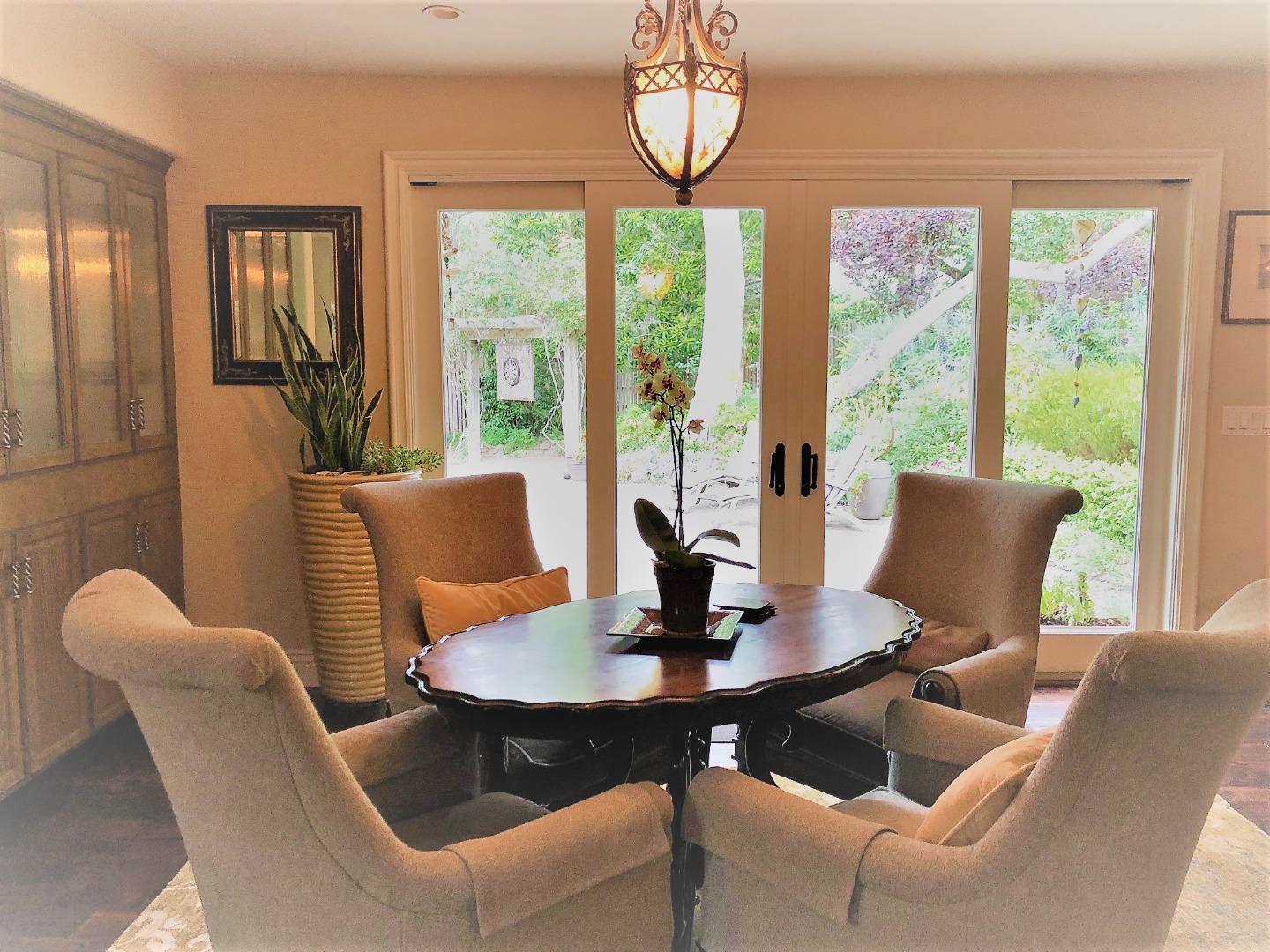 1035 Ortega Road Pebble Beach, CA 93953 - Photo 6 of 18 a view of a dining room with furniture large windows and wooden floor