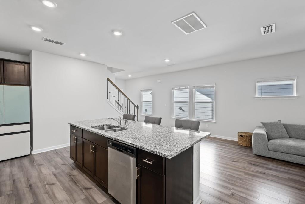 346 Wells Circle Canton, GA 30114 - Photo 15 of 35 a kitchen island with granite countertop a sink and a refrigerator