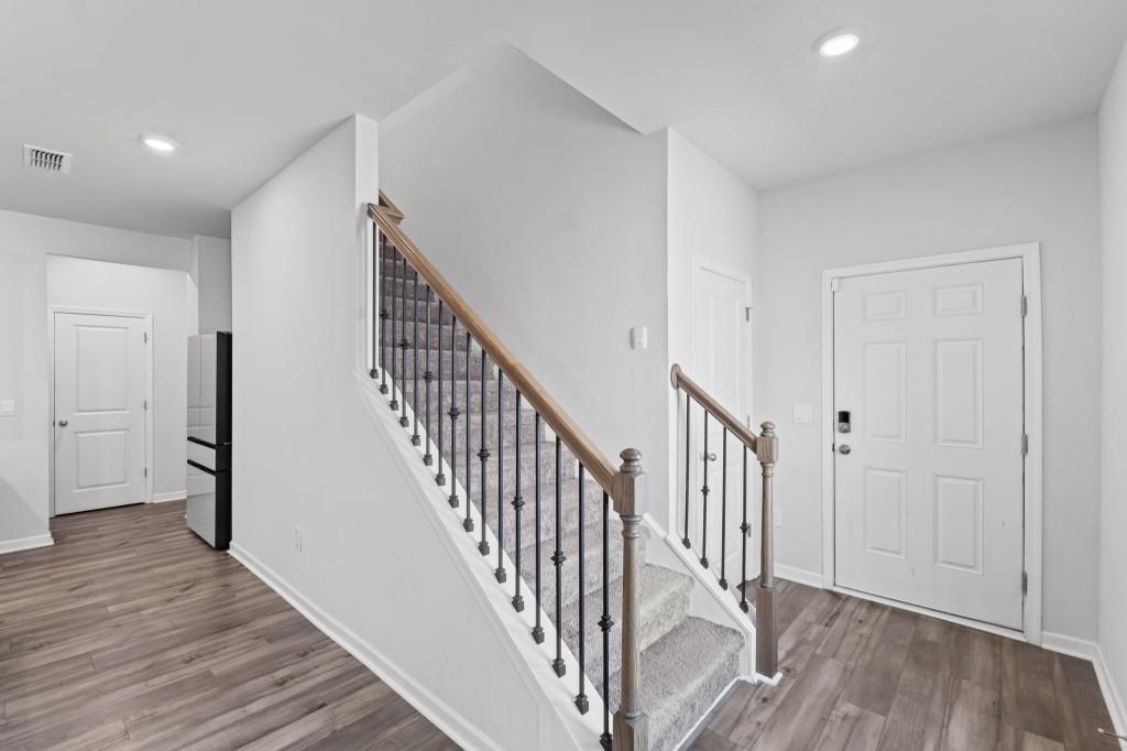 346 Wells Circle Canton, GA 30114 - Photo 18 of 35 a view of a hallway with wooden floor and staircase