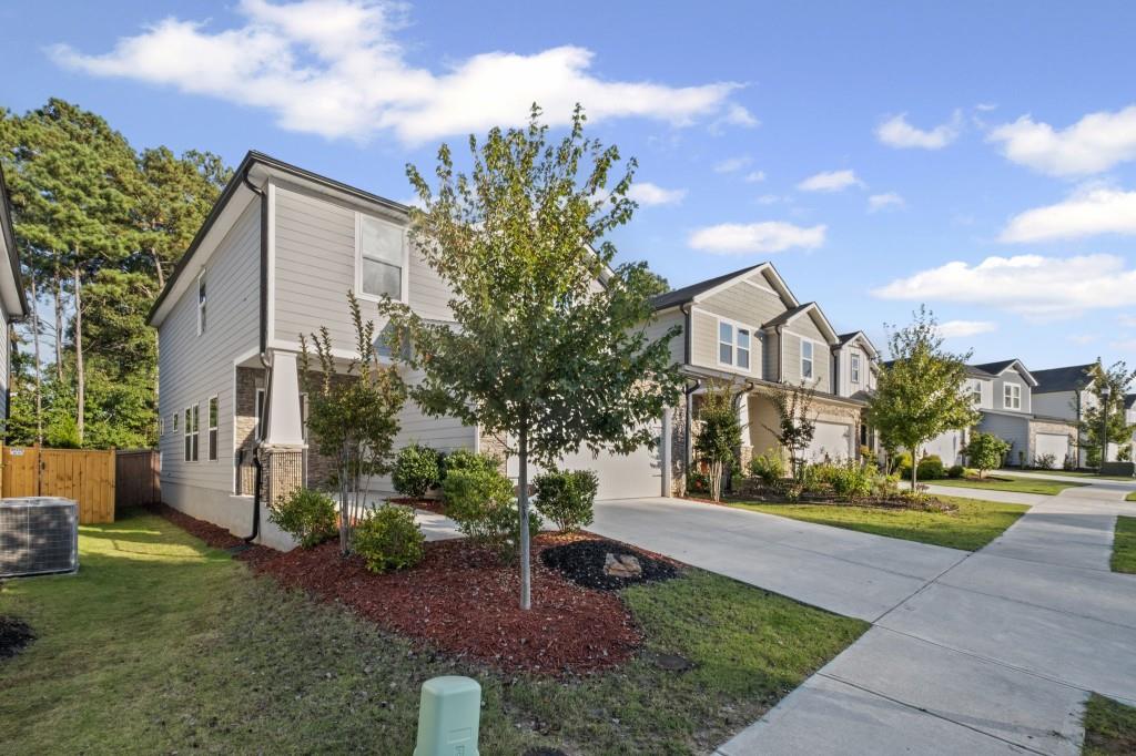 346 Wells Circle Canton, GA 30114 - Photo 2 of 35 a front view of a house with a yard and trees