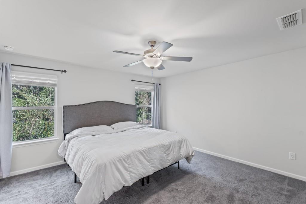 346 Wells Circle Canton, GA 30114 - Photo 22 of 35 a bedroom with a bed and a chandelier