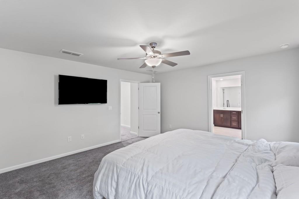 346 Wells Circle Canton, GA 30114 - Photo 23 of 35 a bedroom with a bed and a flat screen tv