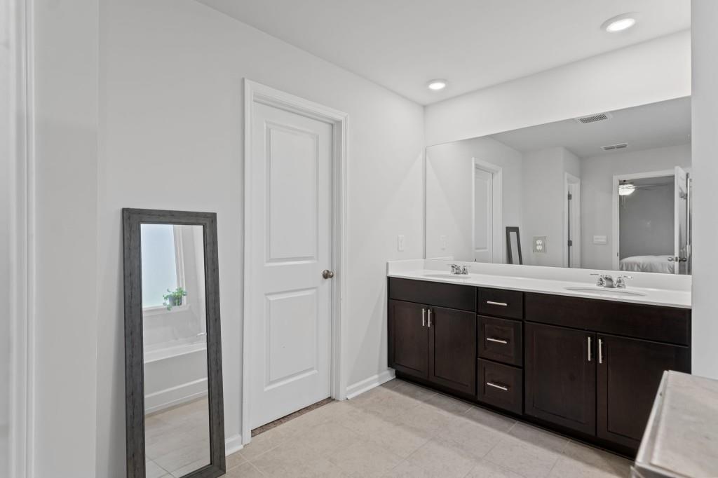 346 Wells Circle Canton, GA 30114 - Photo 25 of 35 a spacious bathroom with a double vanity sink and mirror