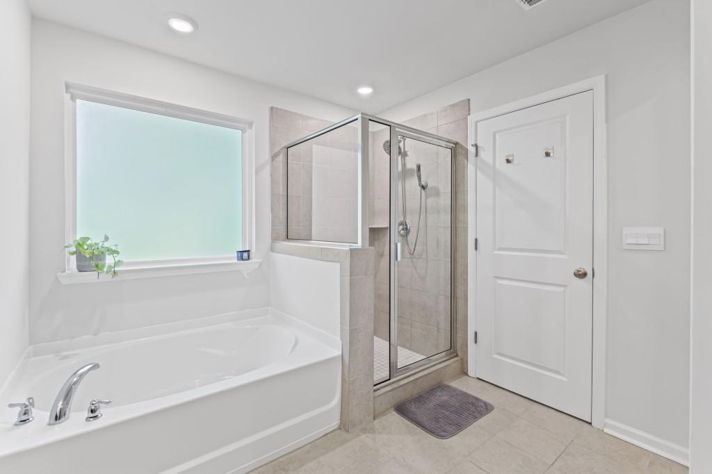 346 Wells Circle Canton, GA 30114 - Photo 26 of 35 a bathroom with a bathtub and a shower