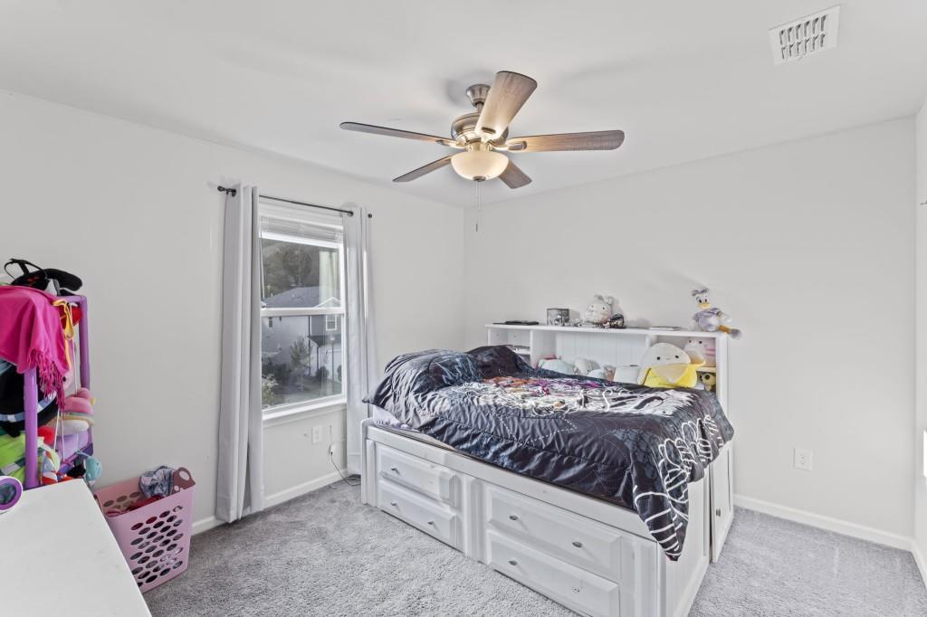 346 Wells Circle Canton, GA 30114 - Photo 27 of 35 a bedroom with a bed and a chandelier