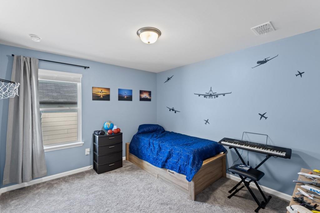 346 Wells Circle Canton, GA 30114 - Photo 28 of 35 a bedroom with a bed and a window