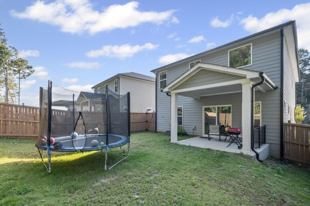 346 Wells Circle Canton, GA 30114 - Photo 33 of 35 a view of a house with backyard porch and sitting area