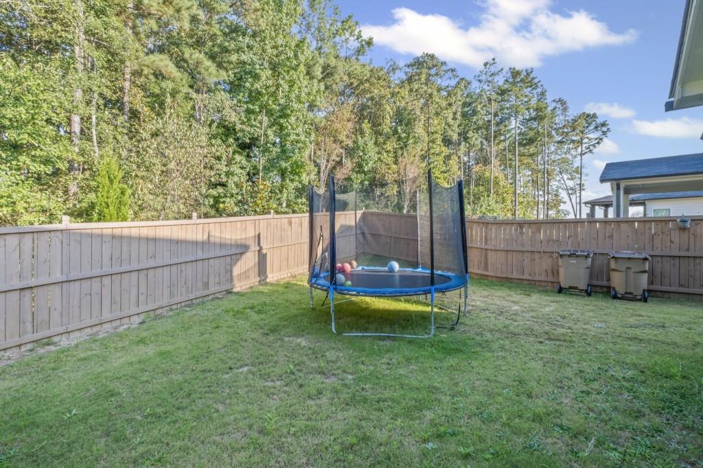 346 Wells Circle Canton, GA 30114 - Photo 34 of 35 a view of a yard with a wooden fence and a bench