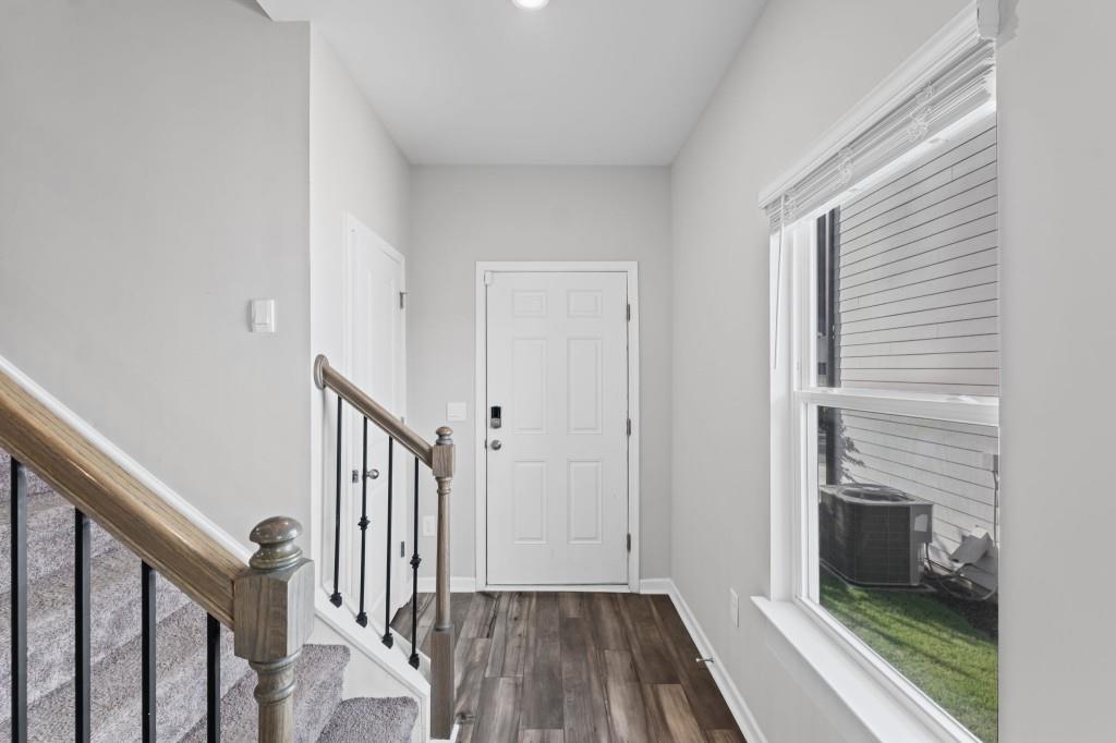 346 Wells Circle Canton, GA 30114 - Photo 6 of 35 a view of a hallway with wooden floor and staircase