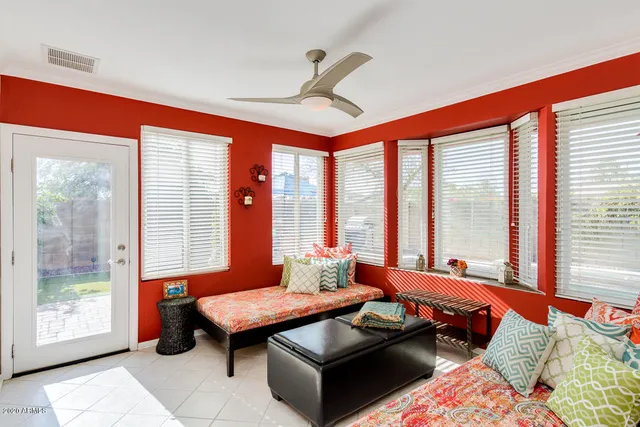 a living room with furniture and large windows