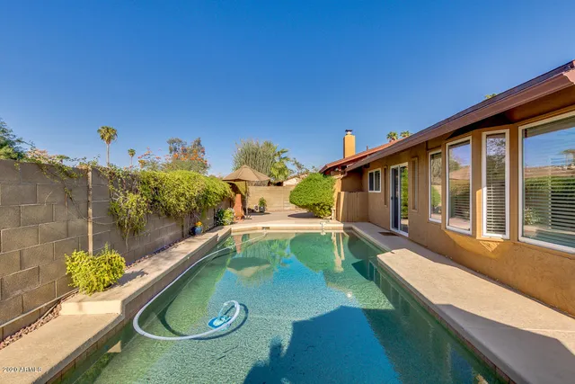 swimming pool view with a seating space