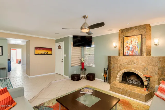 a living room with furniture and a fireplace