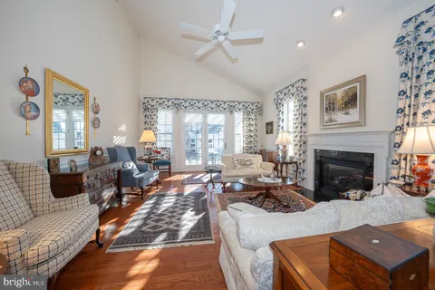 a view of a balcony with wooden floor and outdoor seating