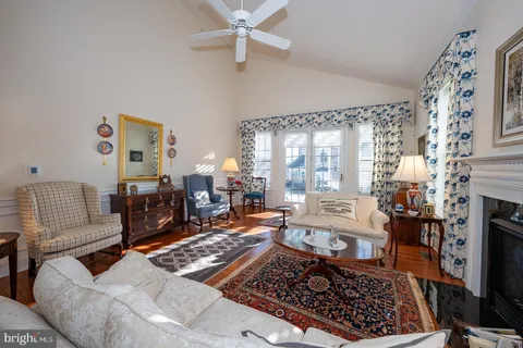 a dining room with furniture a rug and a chandelier