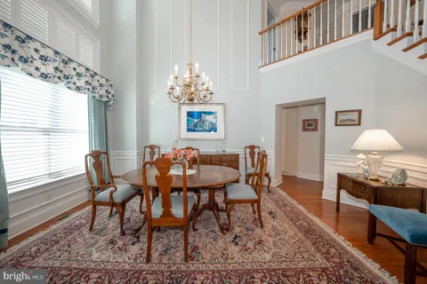 a bedroom with a bed a ceiling fan and a dresser