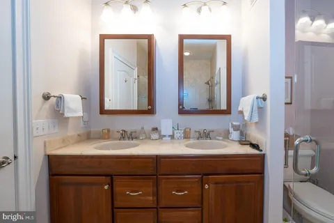 a kitchen with stainless steel appliances granite countertop a refrigerator sink and wooden cabinets