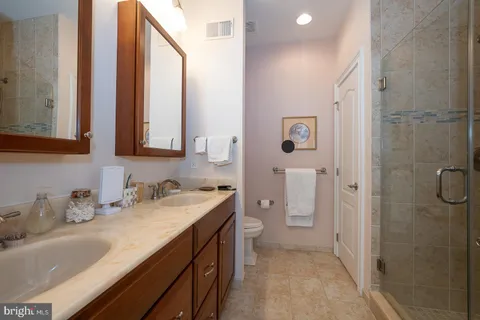 a kitchen with kitchen island granite countertop a sink appliances cabinets and counter space