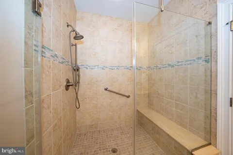 a kitchen with stainless steel appliances granite countertop a sink a stove a refrigerator cabinets and a large window