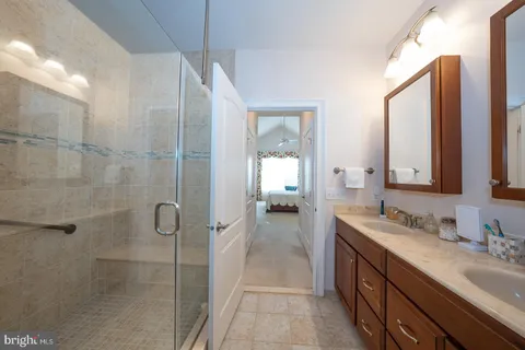 a kitchen with granite countertop white cabinets and stainless steel appliances