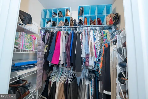 a kitchen with granite countertop white cabinets stainless steel appliances and a sink