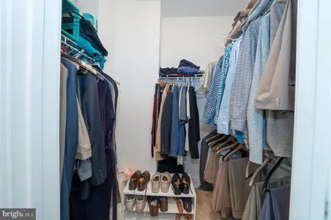 a kitchen with stainless steel appliances granite countertop a refrigerator a sink dishwasher a s stove top oven a large island with white cabinets and wooden floor