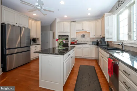 a bathroom with a sink and mirror with toilet