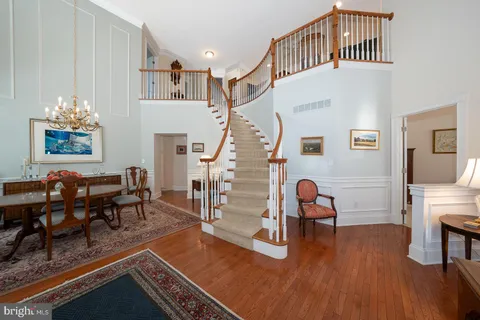a view of an entryway with wooden floor and couches