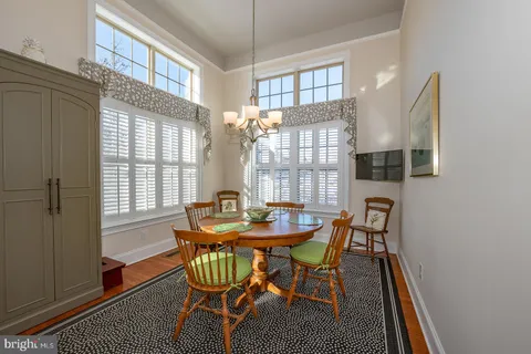 a bathroom with a toilet a double vanity sink and mirror
