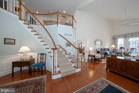 a living room with furniture large window and a fireplace