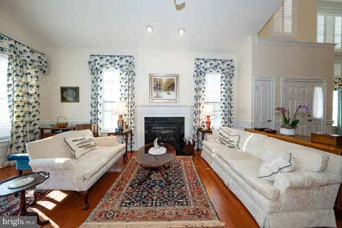 a living room with furniture fireplace and window
