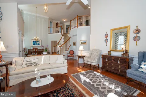 a living room with furniture a fireplace and a potted plant
