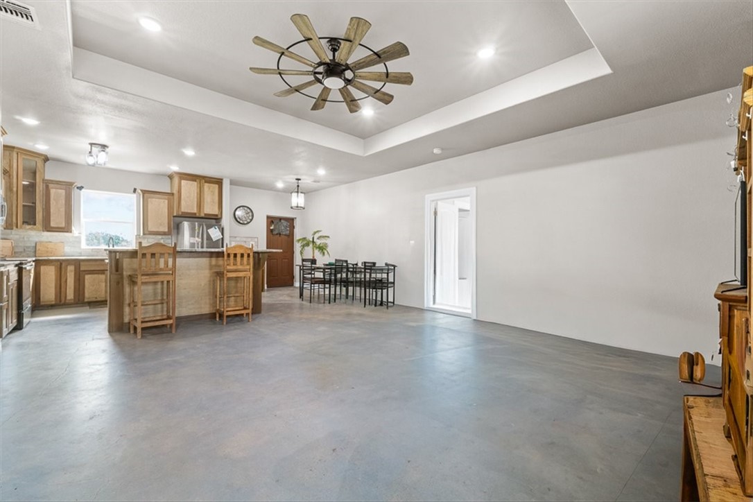 207 South Charles Street George West, TX 78022 - Photo 6 of 24 a view of a kitchen with furniture and a ceiling fan