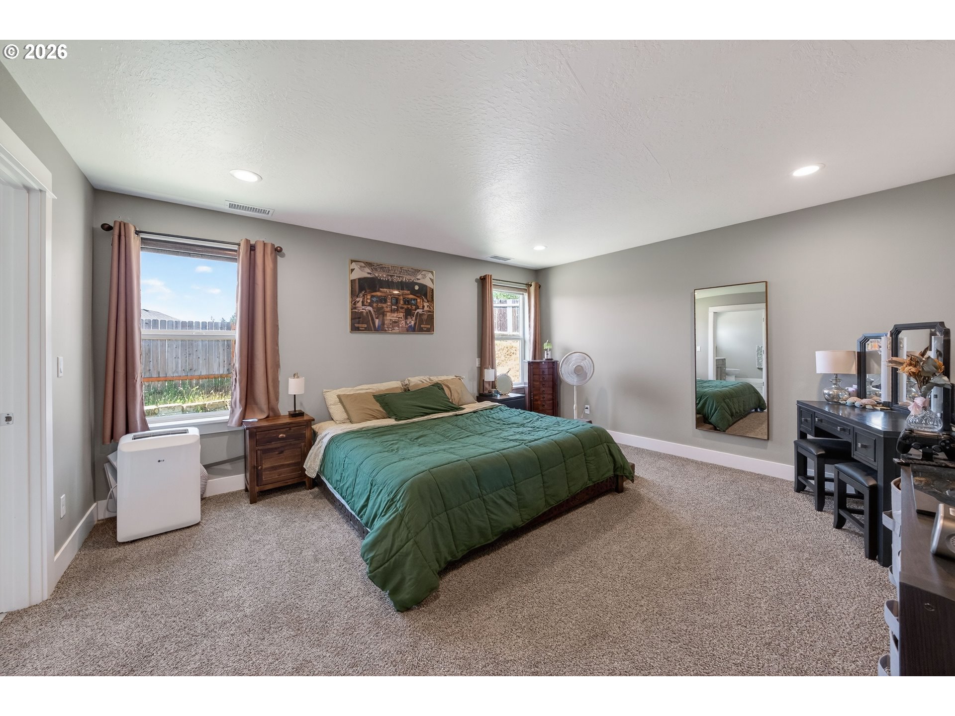 601 Southeast Rose Ridge Drive Winston, OR 97496 - Photo 13 of 40 a bedroom with a large bed and windows