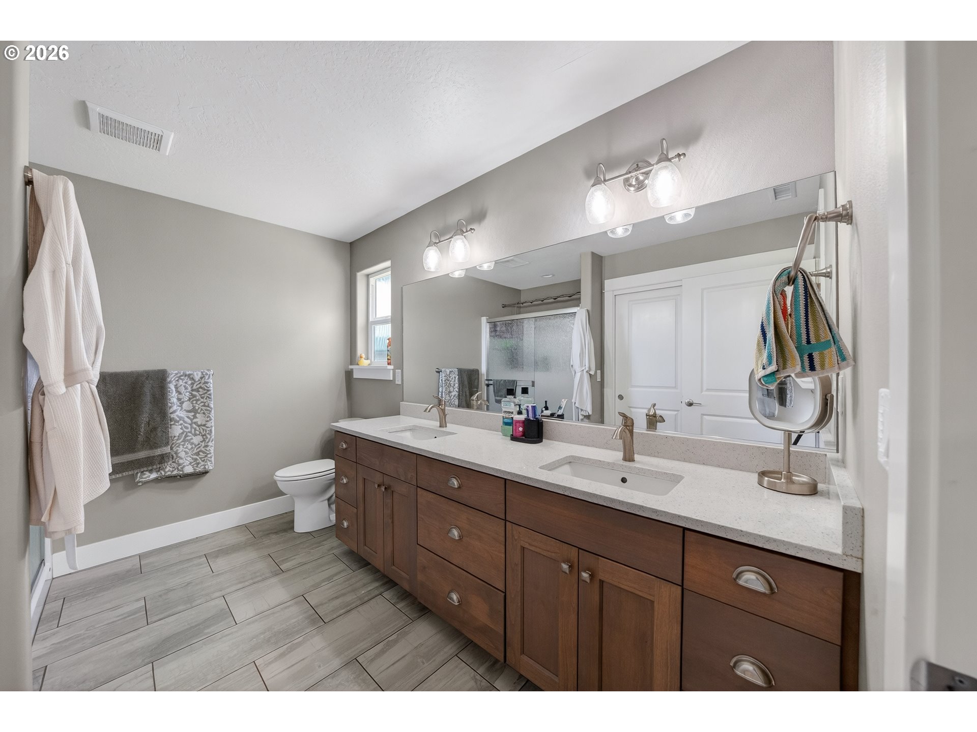 601 Southeast Rose Ridge Drive Winston, OR 97496 - Photo 15 of 40 a bathroom with a double vanity sink a toilet and a mirror