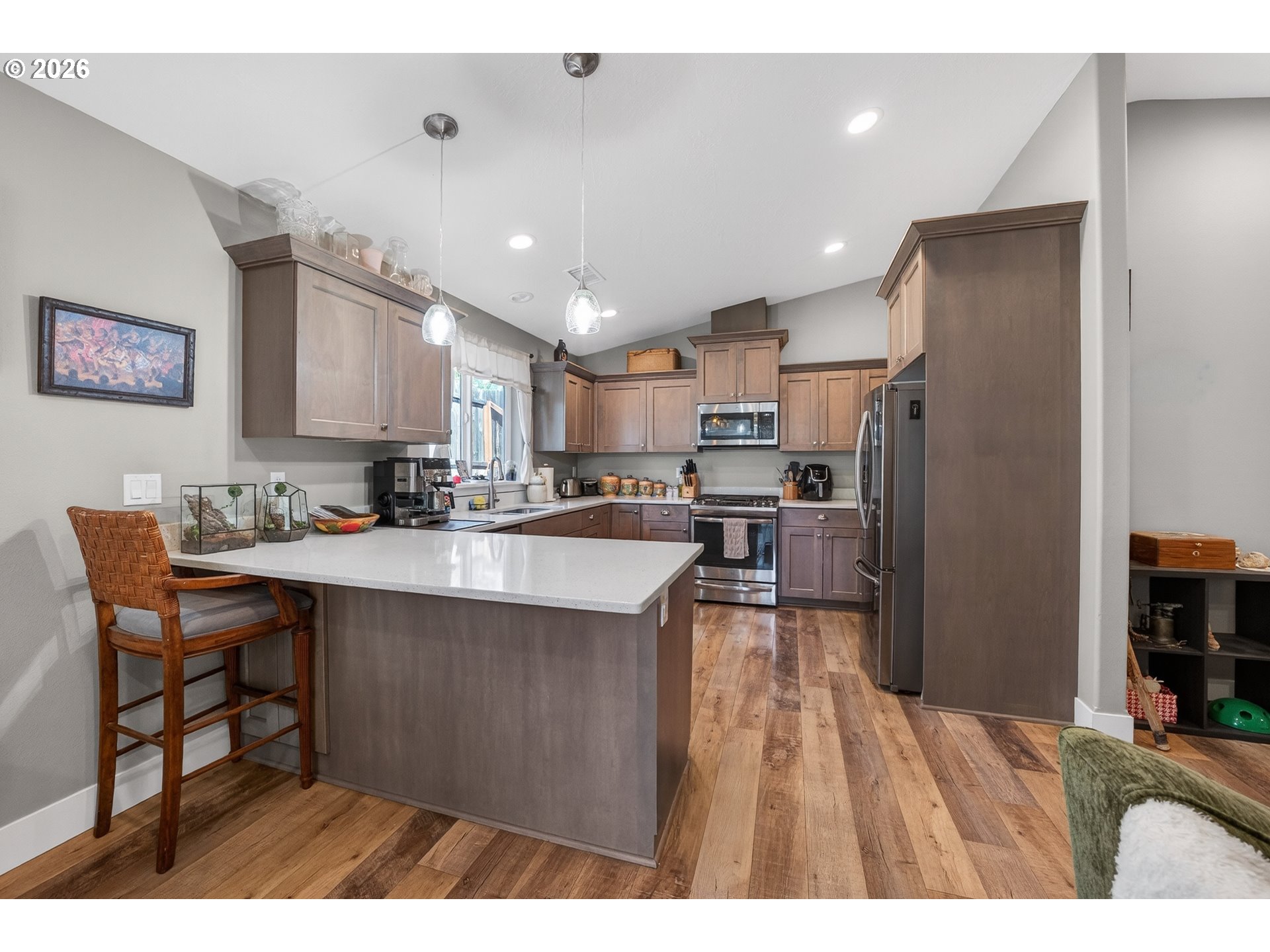 601 Southeast Rose Ridge Drive Winston, OR 97496 - Photo 9 of 40 a kitchen with stainless steel appliances granite countertop a refrigerator a sink a stove a dining table and chairs