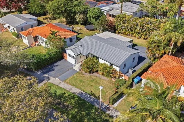 an aerial view of a house with a garden