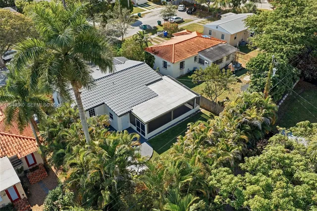 an aerial view of a house with a yard basket ball court and outdoor seating