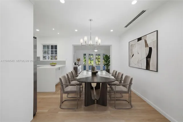 a view of a dining room with furniture and chandelier