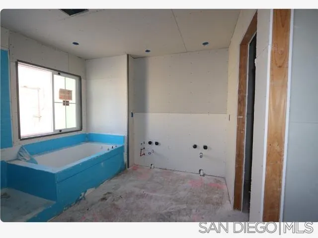 204 Blended Place Fallbrook, CA 92028 - Photo 10 of 18 a bathroom with a tub sink and mirror
