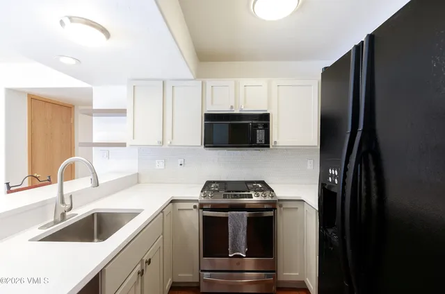 a kitchen with a sink and a refrigerator